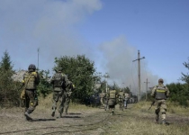 Ukraine leader says Russian forces are in the country as key town falls