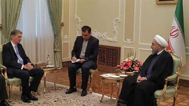 Irans Rouhani receives Britains Hammond