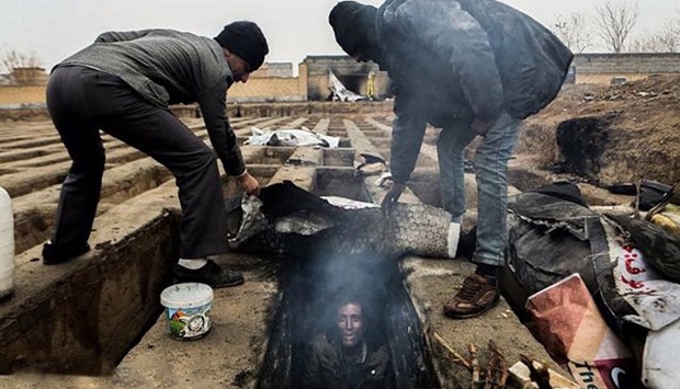 Images of homeless living in graves shock Iran