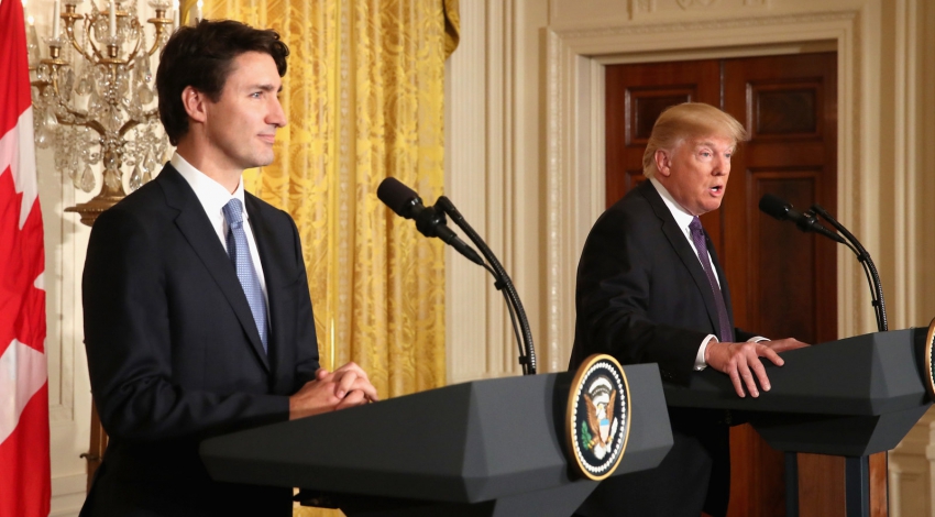 Trump defends travel ban as Trudeau looks on