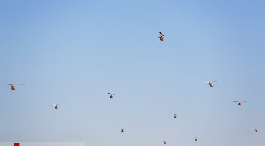 Scores of Iranian Army Aviation helicopters fly over the parade ground