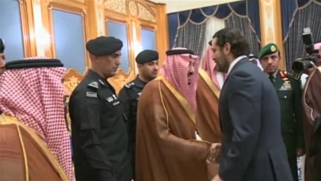 Grim Hariri stands in queue to salute Saudi king