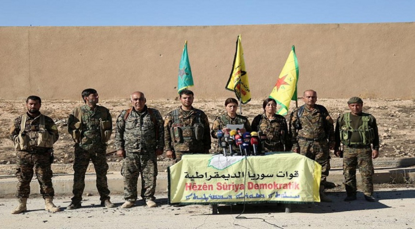 What is pushing Syrian Kurds to seek reunion with Damascus?