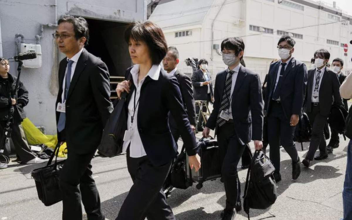 Japanese health ministry officials head to search a Kobayashi Pharmaceutical Co. factory in Osaka