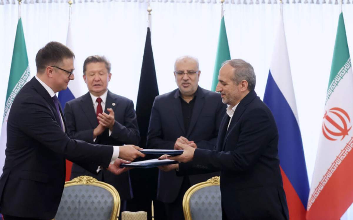 Iranian and Russian representatives exchange documents on supply of Russian pipeline gas to Iran as Gazprom’s head Alexei Miller (L) and Iran