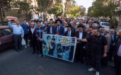 Rabbi Younes Hamami Lalehzar, the leader of Iranian Jews and two other Jewish Rabbis, stand behind a banner during a rally in support of Palestine in downtown Tehran, Oct. 30, 2023.