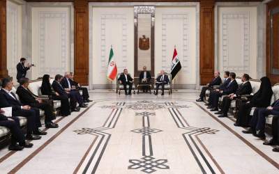 Iran’s President Masoud Pezeshkian (L) meets with his Iraqi counterpart Abdul Latif Rashid in the Arab country’s capital Baghdad on September 11, 2024.