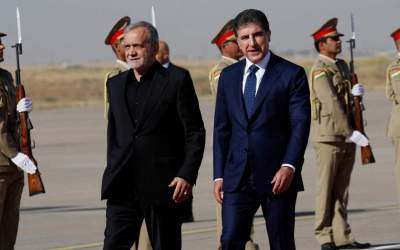 President of the Kurdistan Region of Iraq Nechirvan Barzani (R), welcomes Iranian President Masoud Pezeshkian in the capital Erbil upon his arrival from Baghdad on September 12, 2024.