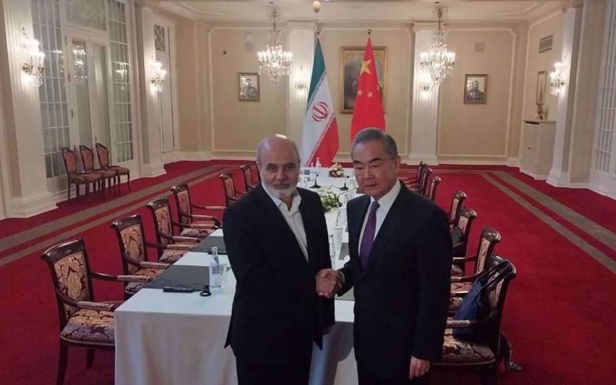 Chinese Foreign Minister Wang Yi (R) shakes hands with Iran’s Supreme National Security Council Ali Akbar Ahmadian in St. Petersburg, Russia, on September 12, 2024. (