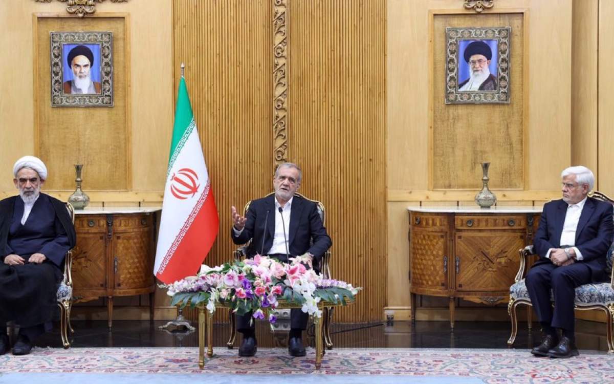 Iranian President Masoud Pezeshkian (center) speaks to reporters at Mehrabad International Airport on September 13, 2024, upon his arrival in the Iranian capital Tehran from Iraq.