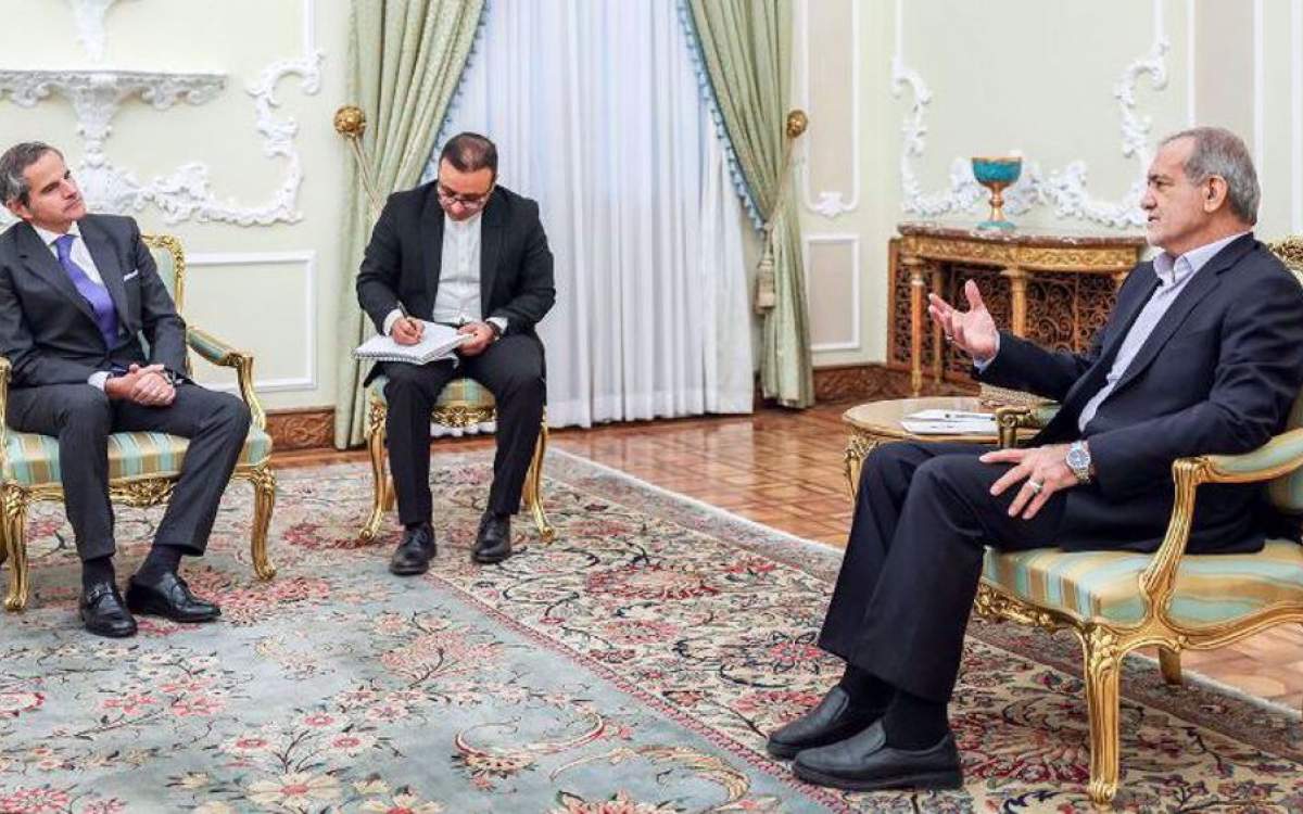 Iranian President Masoud Pezeshkian (R) gestures during a meeting with Director General of the International Atomic Energy Agency (IAEA) Rafael Grossi (L) in the Iranian capital of Tehran, November 14, 2024.