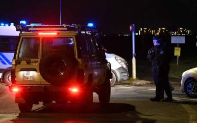 Police cordon off a migrant camp on a road between Mardyck and Loon Beach where two security guards and two migrants were shot dead, near Dunkirk, northern France, on December 14, 2024. The fifth person was killed in the commune of Wormhout.