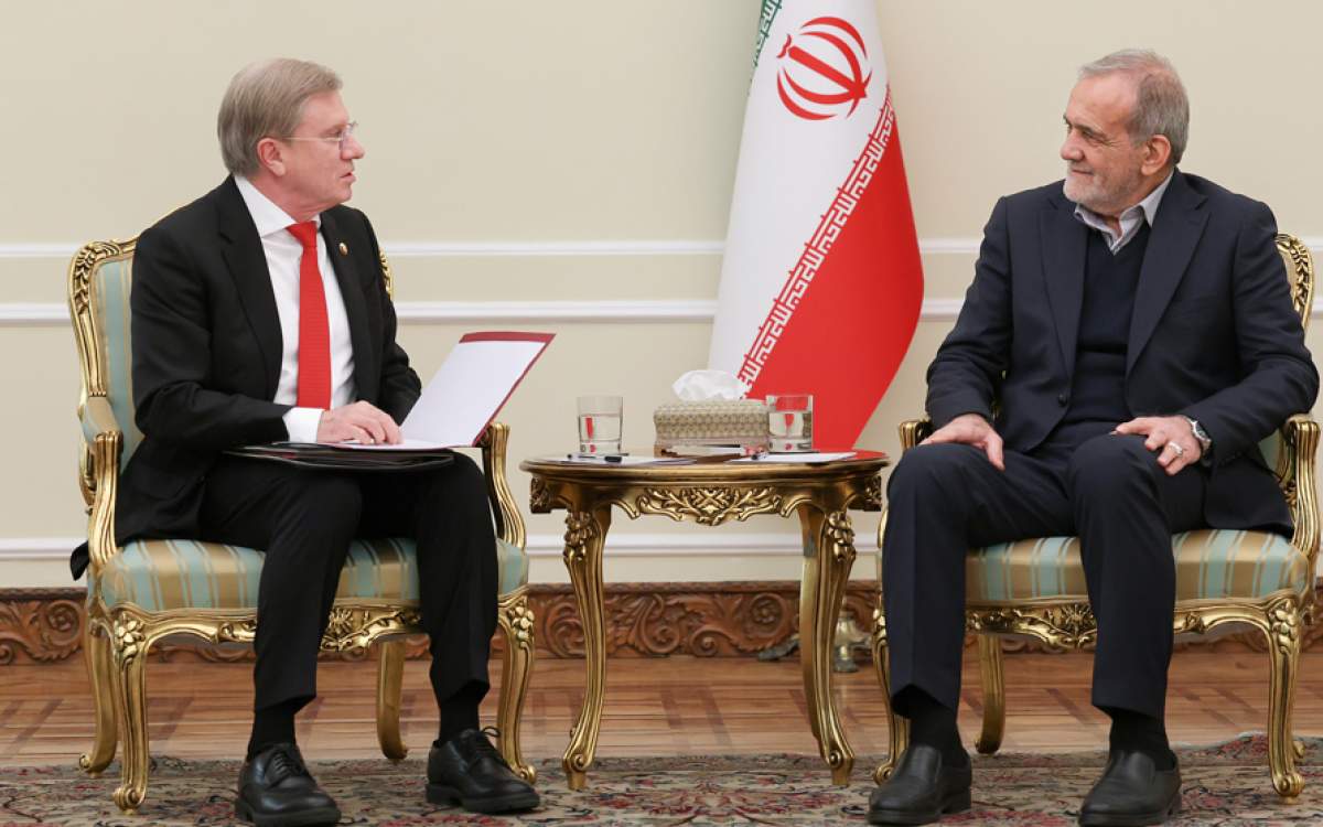 Iranian President Masoud Pezeshkian (R) and Russian Deputy Prime Minister for Transport Vitaly Gennadyevich Savelyev meet in Tehran on December 23, 2024.