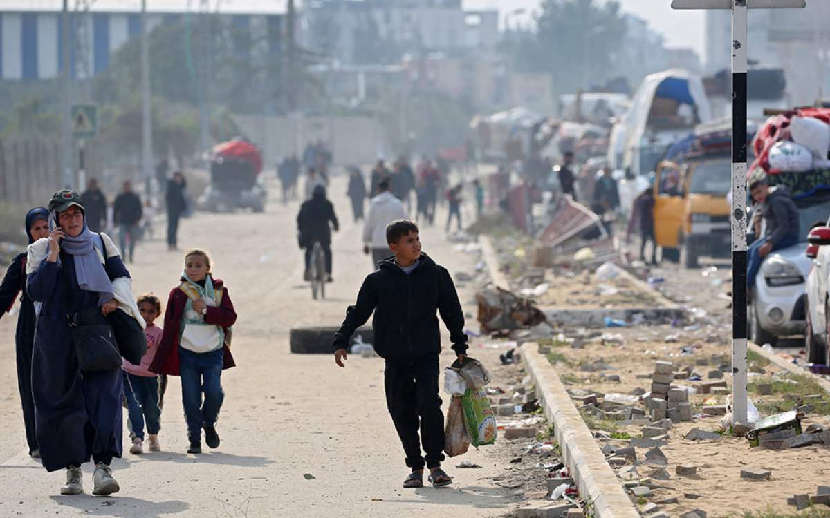 Displaced Palestinians walk along Salah al-Din road in Nuseirat as they make their way to the northern part of the Gaza Strip on January 28, 2025.