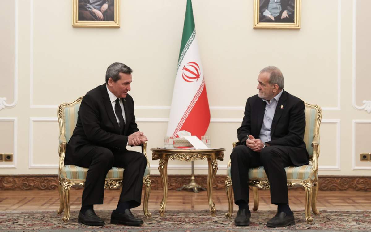 Iranian President Masoud Pezeshkian, right, meets Turkmenistan