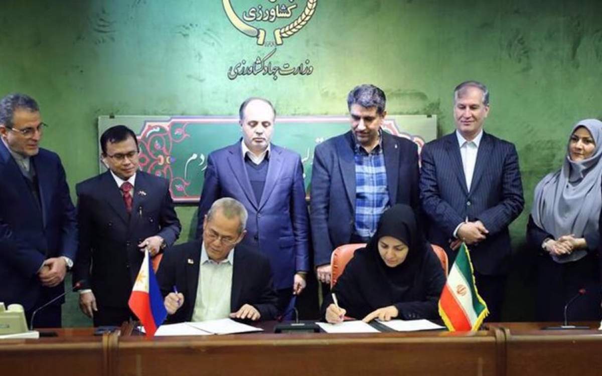 Philippine’s Agriculture Undersecretary Zamzamin Ampatuan (sitting-L) signs cooperation agreements in the Iranian Ministry of Agriculture in the capital Tehran on February 25, 2025.